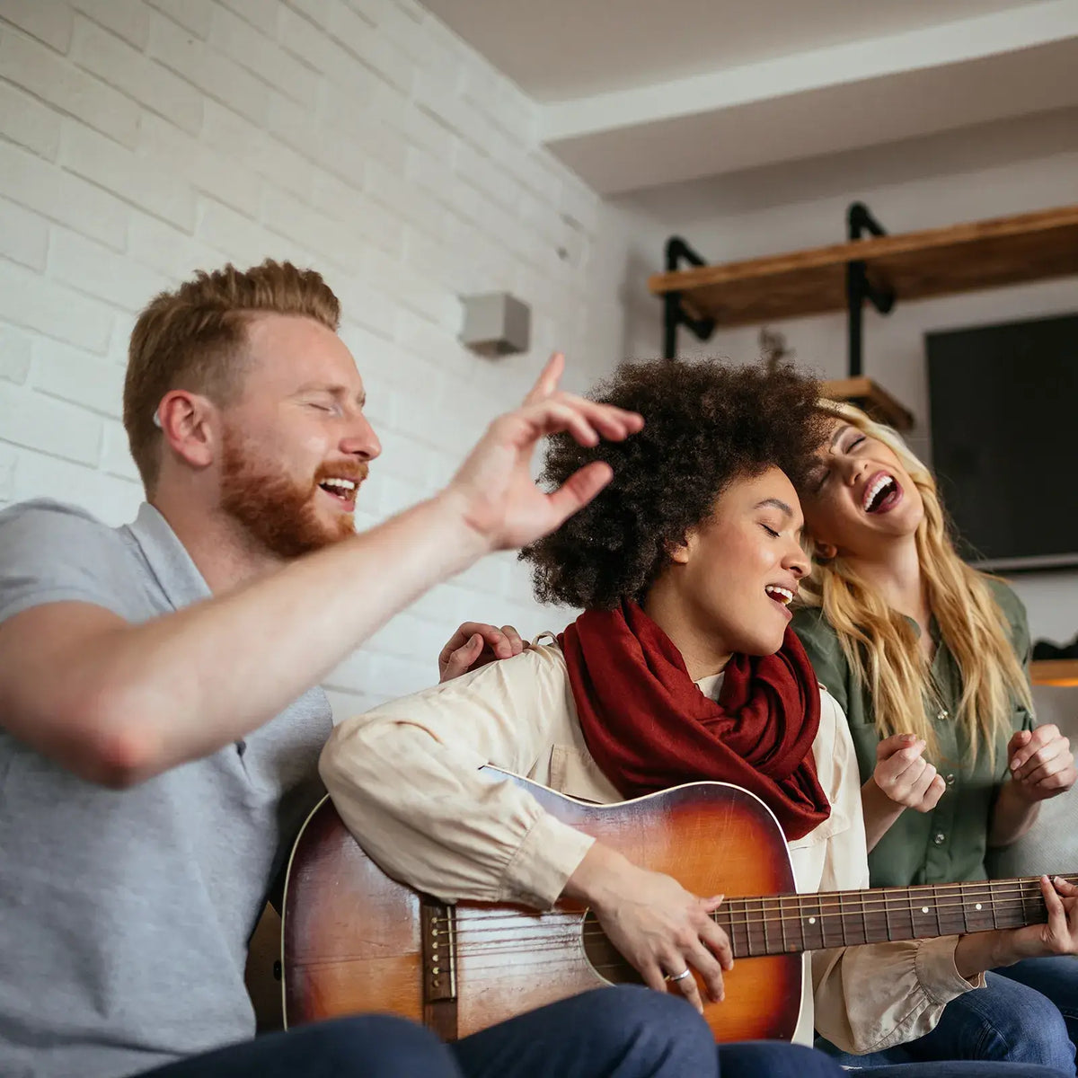 People singing and playing acoustic guitar, showing hearing aid music mode and clear speech