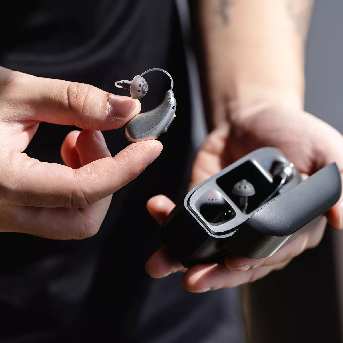 ELEHEAR rechargeable hearing aids with charging case held in hand