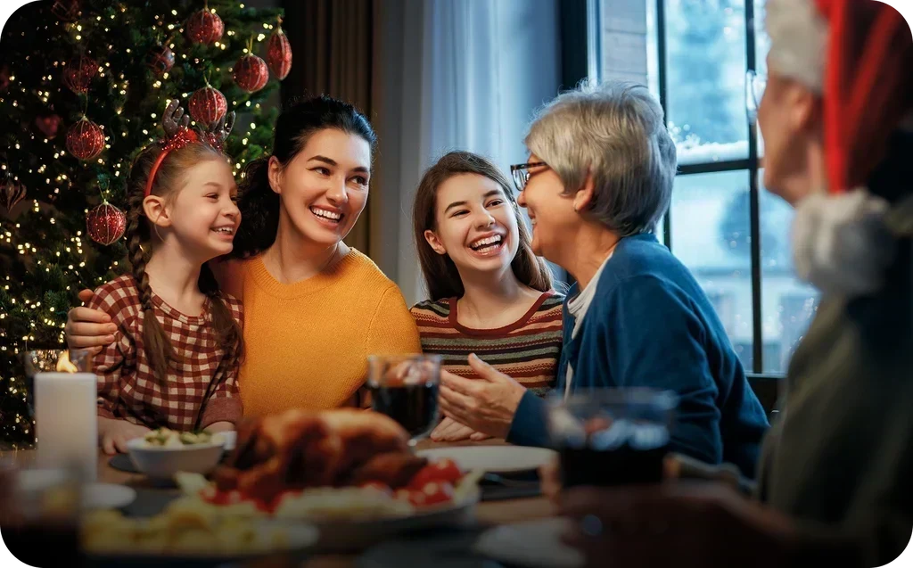 Warm family gathering at a festive dinner table, sharing happy conversations during holiday celebrations.