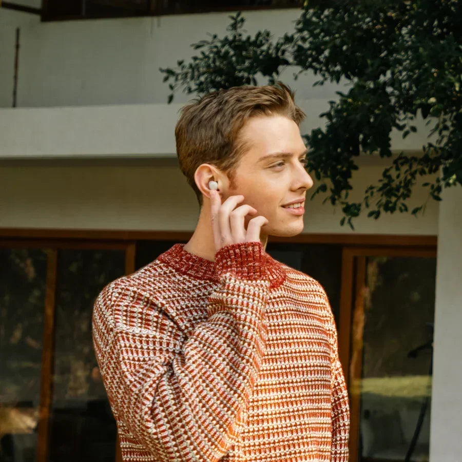 Man wearing Bluetooth hearing aids outdoors for clearer phone calls and everyday listening