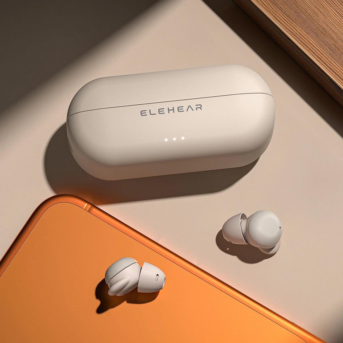 White wireless earbuds with charging case on a beige surface