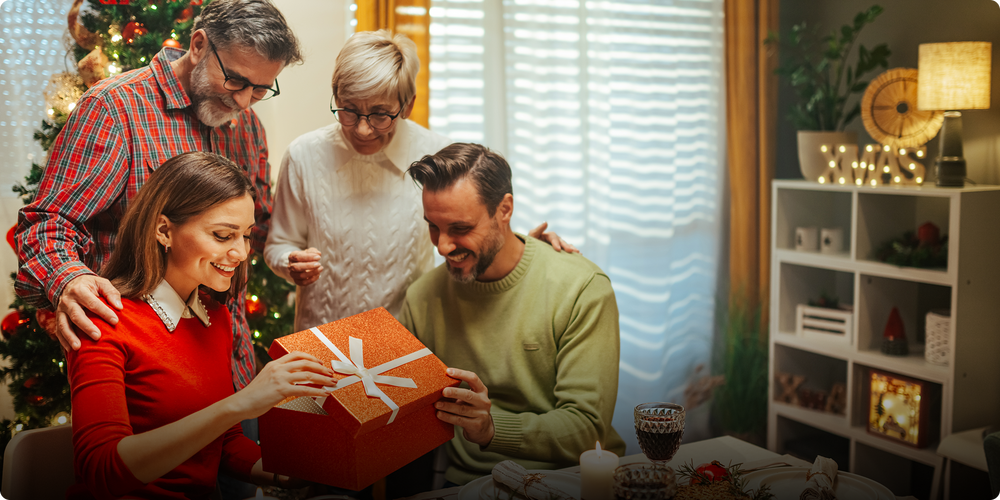 Family gathered around a gift exchange, with a festive atmosphere.