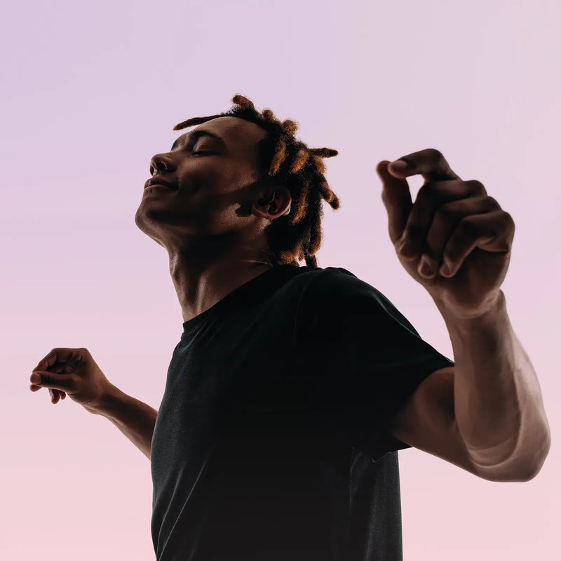 Man listening to music with hearing aids showing enhanced audio quality and music mode feature